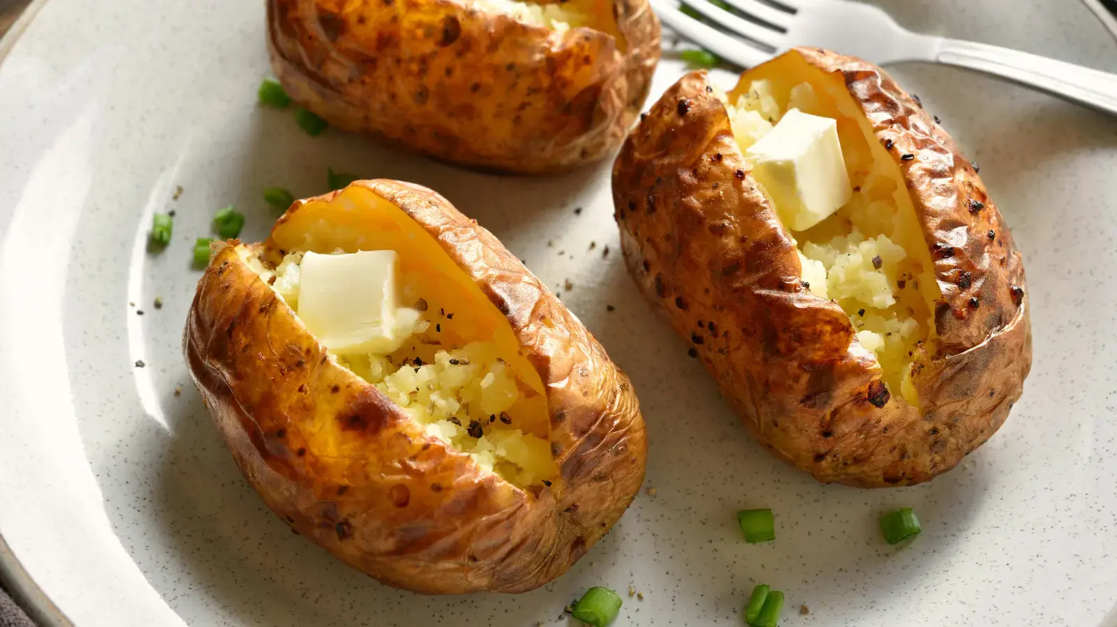 Canned seafood transforms simple baked potatoes into a flavor-packed meal