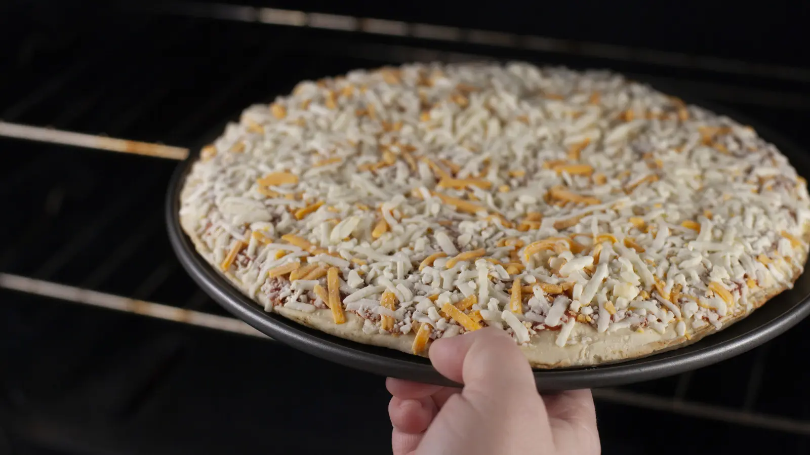 Leftover rotisserie chicken transforms basic frozen cheese pizza into a gourmet meal
