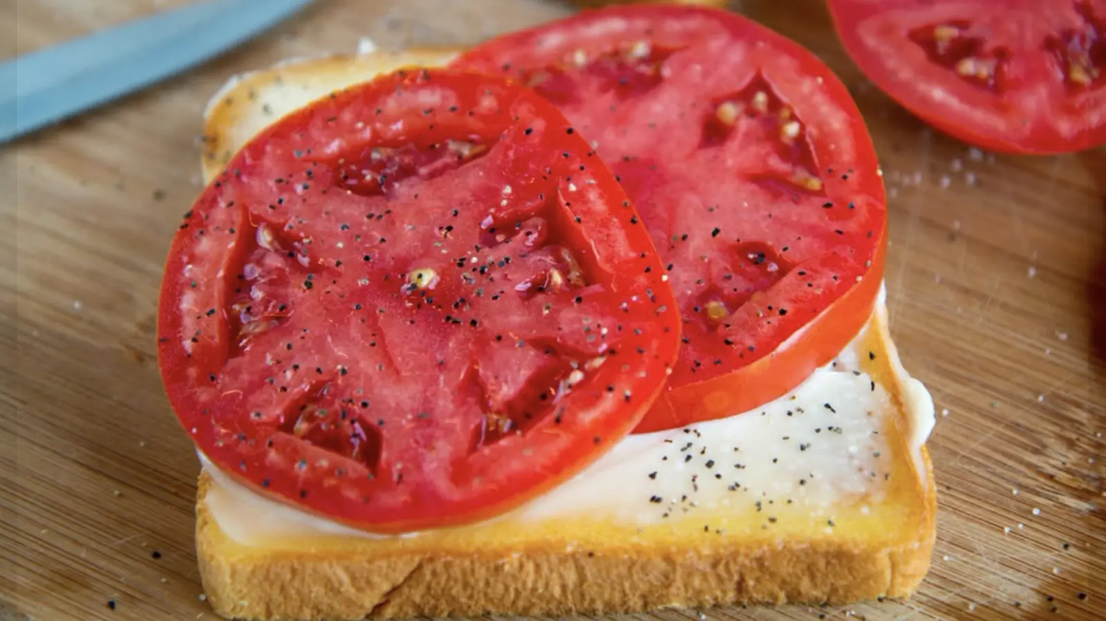Give Tomato Sandwiches An Extra Layer Of Flavor With A Sprinkle Of This Pantry Staple
