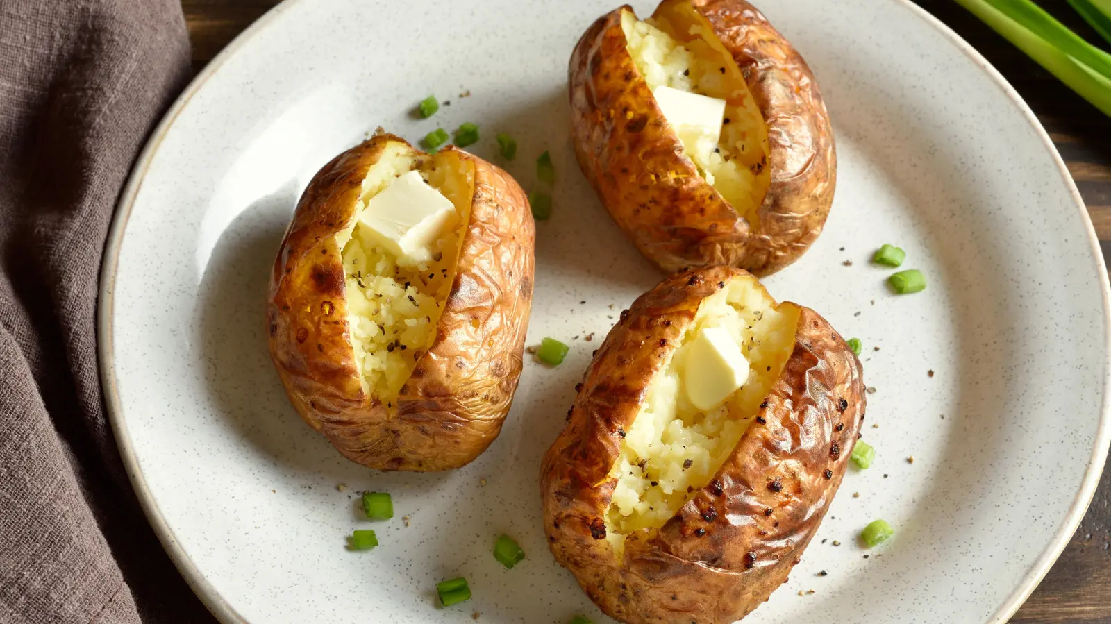 Stop Slicing Baked Potatoes In Half — Cut Them Like This For Flavor In Every Bite